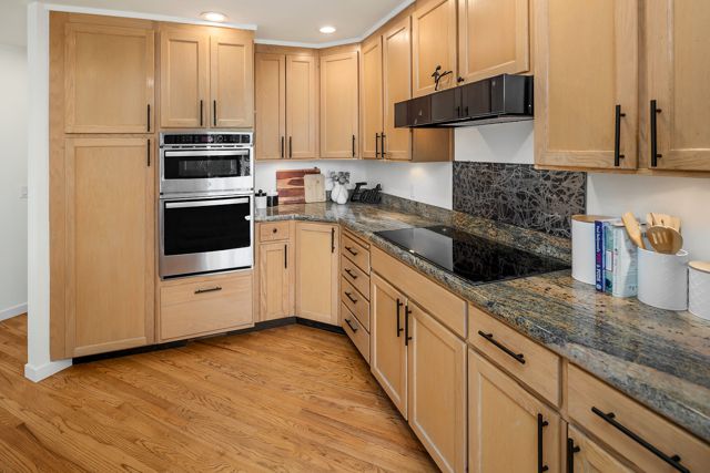 Empty kitchen showing full cabinet layout